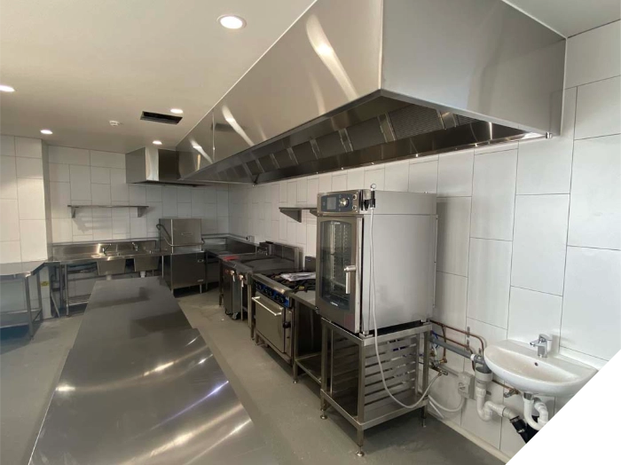 Stainless steel commercial kitchen exhaust canopy and benches